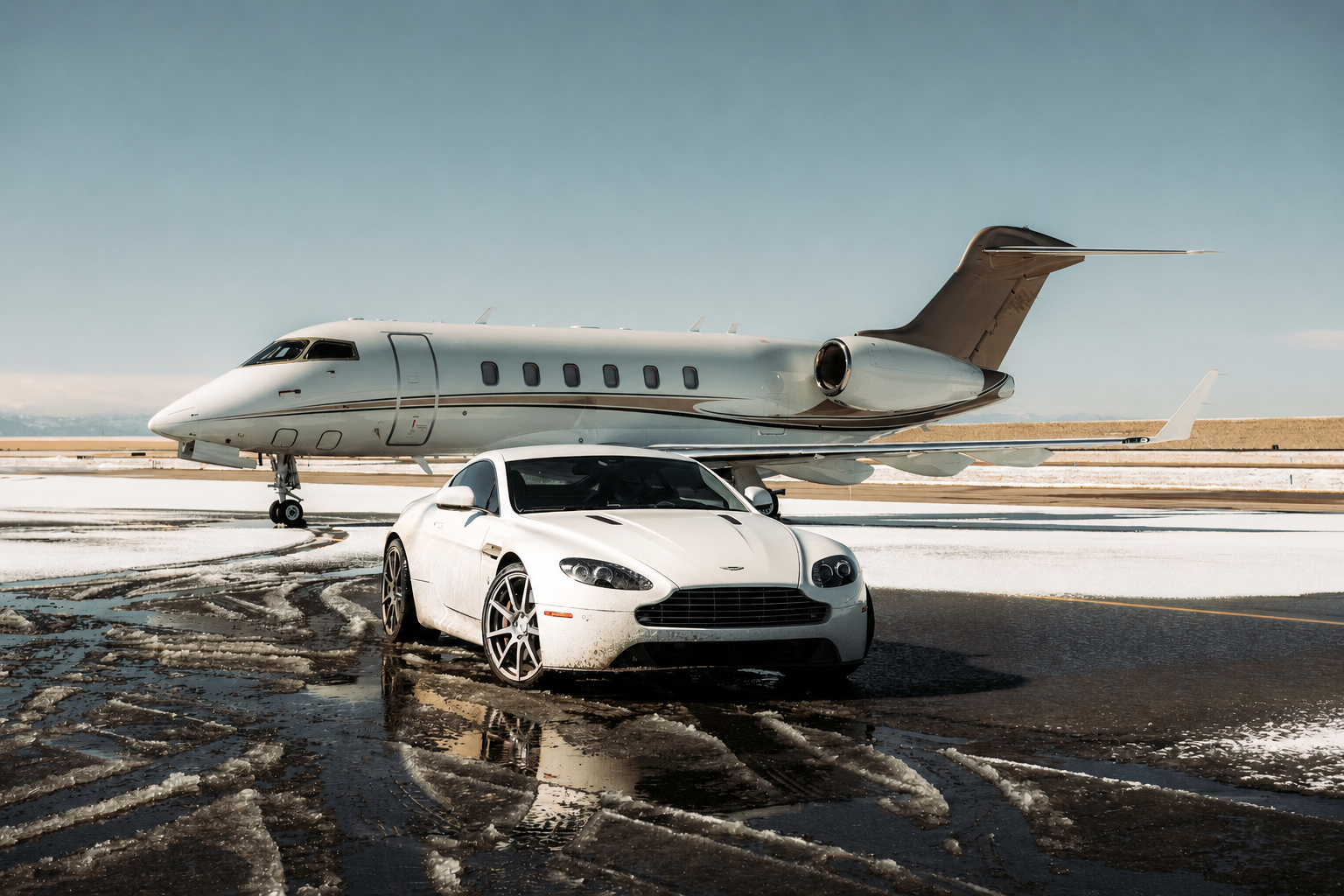 Aston Martin positioned in front of a private aircraft